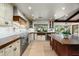 Spacious kitchen with custom cabinetry, stainless steel appliances, and a butcher block island at 8325 N 73Rd Pl, Scottsdale, AZ 85258