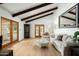 Bright living room with wood floors, exposed beams, and French doors, creating a cozy atmosphere at 8325 N 73Rd Pl, Scottsdale, AZ 85258