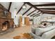 Cozy living room featuring a fireplace, wood beams, and a view of the open floor plan at 8325 N 73Rd Pl, Scottsdale, AZ 85258