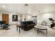 Spacious living room with tile floors, a gray sofa, and a Peloton exercise bike at 8325 N 73Rd Pl, Scottsdale, AZ 85258