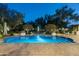 Serene pool and outdoor seating area with lush gardens and mature trees at 8325 N 73Rd Pl, Scottsdale, AZ 85258