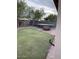 Spacious backyard featuring artificial turf, a trampoline, and privacy fencing at 8929 E Bramble Ave, Mesa, AZ 85208