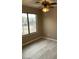 The bedroom features a ceiling fan and a large window at 8929 E Bramble Ave, Mesa, AZ 85208