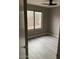 The bedroom features a ceiling fan and a large window at 8929 E Bramble Ave, Mesa, AZ 85208