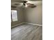 The bedroom features a ceiling fan and a large window at 8929 E Bramble Ave, Mesa, AZ 85208