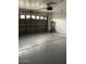 Attached garage with an automatic door opener, white walls, and ample space for two vehicles at 8929 E Bramble Ave, Mesa, AZ 85208