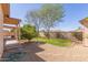 Backyard featuring mature landscaping, including grass, trees and gravel at 9022 N 39Th Ave, Phoenix, AZ 85051