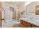 Bathroom featuring a shower, a window, a sink, and a toilet at 9022 N 39Th Ave, Phoenix, AZ 85051
