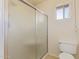 Bathroom featuring a frosted glass shower, toilet, and a window letting in natural light at 9022 N 39Th Ave, Phoenix, AZ 85051