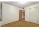 Bedroom with carpet, white walls, a doorway and a double door closet at 9022 N 39Th Ave, Phoenix, AZ 85051