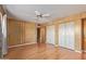 Sunny bedroom featuring hardwood floors, ceiling fan, and closet at 9022 N 39Th Ave, Phoenix, AZ 85051