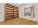 Bedroom featuring carpet, a window, white walls, and a built-in bookshelf at 9022 N 39Th Ave, Phoenix, AZ 85051