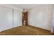 Bedroom featuring carpet, a double door closet, white walls, and a doorway at 9022 N 39Th Ave, Phoenix, AZ 85051