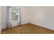 Bedroom featuring a window with blue patterned curtains, carpeted floors, and white walls at 9022 N 39Th Ave, Phoenix, AZ 85051