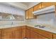 Close-up of kitchen featuring classic wooden cabinets and modern appliances and great natural light at 9022 N 39Th Ave, Phoenix, AZ 85051