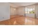Open-concept living room with hardwood floors, large window, and chandelier at 9022 N 39Th Ave, Phoenix, AZ 85051
