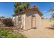 Charming outbuilding in backyard with neutral paint, window, and door with stone walkway at 9022 N 39Th Ave, Phoenix, AZ 85051