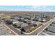 High-angle view showcases a structured community layout with consistent home styles, roads, and desert backdrop at 11447 E Utah Ave, Mesa, AZ 85212