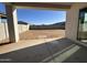 Covered back patio overlooking an empty lot with block wall and ready for landscaping at 11447 E Utah Ave, Mesa, AZ 85212