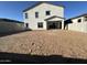 Exterior view of the backyard featuring a spacious dirt lot ready for landscaping at 11447 E Utah Ave, Mesa, AZ 85212