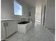 Bright bathroom with hexagonal tile flooring, soaking tub, and built-in vanity at 11447 E Utah Ave, Mesa, AZ 85212