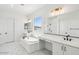 Modern bathroom featuring dual sinks, a soaking tub, and sleek fixtures at 11447 E Utah Ave, Mesa, AZ 85212