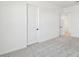Bright bedroom with gray carpet and white walls, with doors to closet and outside the room at 11447 E Utah Ave, Mesa, AZ 85212