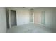 Unfinished bedroom with three doorways, neutral paint and lighting fixtures at 11447 E Utah Ave, Mesa, AZ 85212