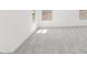 Bright room with gray carpet, neutral walls and bright sunlit windows at 11447 E Utah Ave, Mesa, AZ 85212