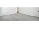 Bright bedroom with gray carpet and white walls, with doors to closet and outside the room at 11447 E Utah Ave, Mesa, AZ 85212