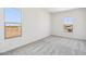 Bright bedroom with gray carpet, natural light and view to rooftops from the double paned window at 11447 E Utah Ave, Mesa, AZ 85212