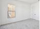 Bedroom featuring neutral carpet, a window, and a closet door at 11447 E Utah Ave, Mesa, AZ 85212