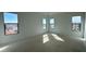 Unfinished bedroom with neutral paint, lighting fixtures and multiple windows at 11447 E Utah Ave, Mesa, AZ 85212