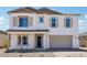 Two-story home with a neutral color scheme, two-car garage, and low maintenance front yard at 11447 E Utah Ave, Mesa, AZ 85212