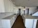 Elegant kitchen featuring white cabinets, quartz countertops, and a spacious island at 11447 E Utah Ave, Mesa, AZ 85212