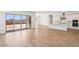 View of a kitchen and living room with hardwood floors, a large island, and an open floor plan at 11447 E Utah Ave, Mesa, AZ 85212