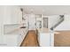 Modern kitchen with white cabinets, hardwood flooring, and stainless steel appliances at 11447 E Utah Ave, Mesa, AZ 85212
