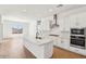 Bright kitchen with a large island, stainless steel appliances, and wood-look tile flooring at 11447 E Utah Ave, Mesa, AZ 85212