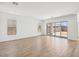 Spacious living room featuring sliding glass doors to the backyard and hardwood flooring at 11447 E Utah Ave, Mesa, AZ 85212