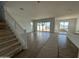 Expansive open-concept room with stairs, tile flooring, and sliding glass doors, perfect for entertaining at 11447 E Utah Ave, Mesa, AZ 85212