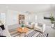Upstairs living area featuring a striped rug, two armchairs, and a bookshelf at 11447 E Utah Ave, Mesa, AZ 85212