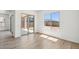 Bright living room with sliding glass doors to patio and wood-look tile flooring at 11447 E Utah Ave, Mesa, AZ 85212
