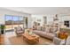 Bright living room with neutral tones, modern furniture, and sliding doors to the backyard at 11447 E Utah Ave, Mesa, AZ 85212