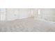Large upstairs loft with neutral carpet, white walls, and an open railing at 11447 E Utah Ave, Mesa, AZ 85212