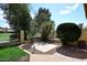 Private backyard area with mature landscaping, brick patio, and views of the golf course at 1227 E Sheena Dr, Phoenix, AZ 85022