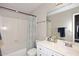 Clean bathroom with a shower-tub combo and a white vanity with ample counter space at 1227 E Sheena Dr, Phoenix, AZ 85022