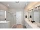 Spacious bathroom featuring dual sinks, a large mirror, a tiled shower, and neutral paint at 1227 E Sheena Dr, Phoenix, AZ 85022