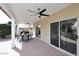 Spacious covered patio featuring a ceiling fan, brick flooring, and sliding glass doors to the interior at 1227 E Sheena Dr, Phoenix, AZ 85022