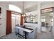 Dining area with high ceilings, modern chandelier, and gray upholstered chairs at 1227 E Sheena Dr, Phoenix, AZ 85022