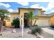 Inviting two-story home featuring a tile roof, stucco exterior, desert landscaping, and an attached two car garage at 1227 E Sheena Dr, Phoenix, AZ 85022